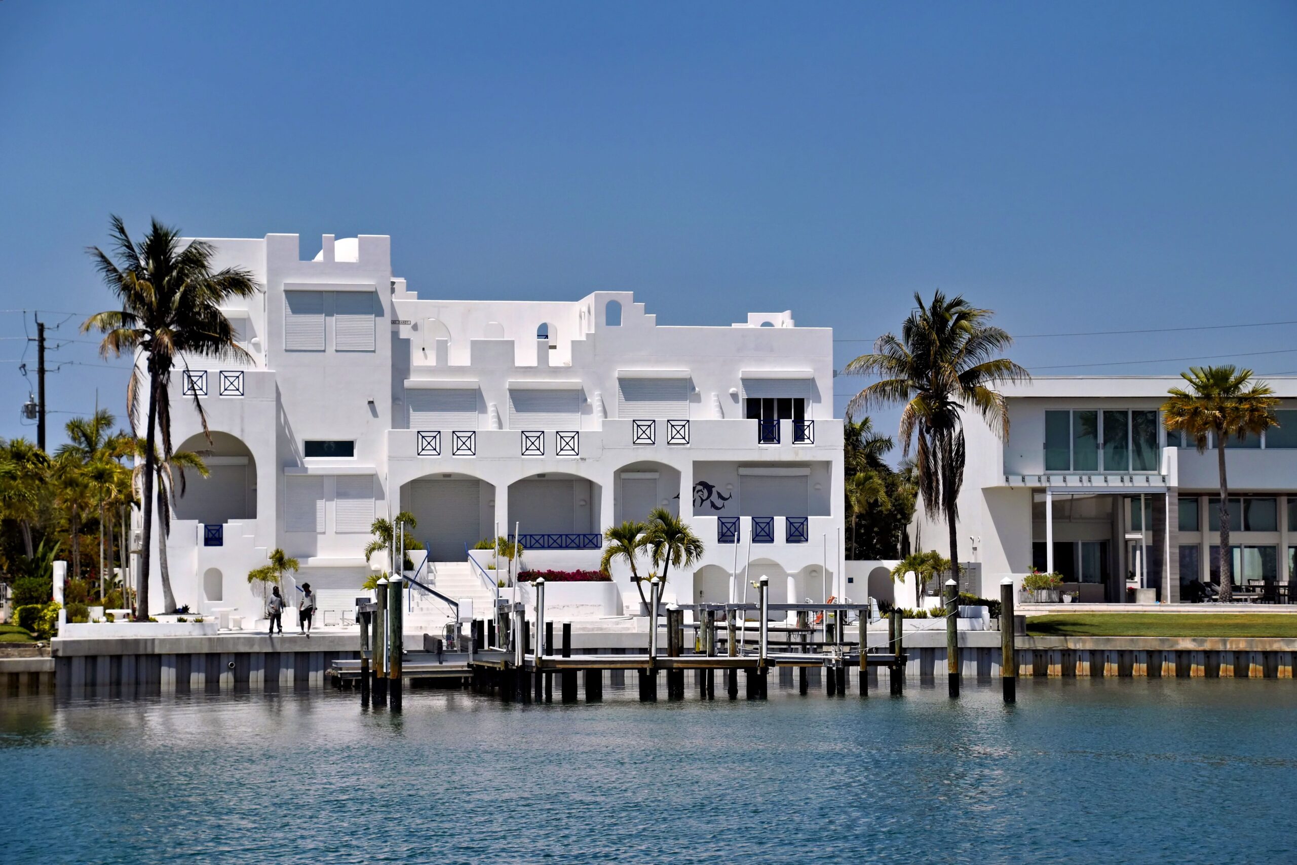 Stunning white modern waterfront house in sunny Sarasota, Florida alongside tranquil waterway.